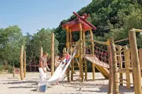 Kinderen glijden van de glijbaan in 1 van de speeltuinen